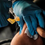 Image: A Jackson-Hinds Comprehensive Health Center nurse administers a Pfizer Covid-19 booster vaccine at an inoculation station next to Jackson State University in Jackson, Miss., on Nov. 18, 2022