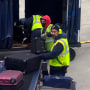 American Airlines baggage handlers load luggage on an airplane at O'Hare International Airport, in Chicago
