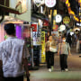 People walk down a street in Seoul, South Korea