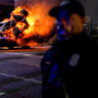 Firefighters work to extinguish a fire after an Atlanta police vehicle was set on fire during a "Stop cop city" protest in Atlanta on Jan. 21, 2023.