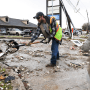 Deer Park city employees clear debris after a powerful storm system swept through the area