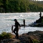 Anglers fish for sockeye salmon along the rapids of the Newwhalen River near Iliamna, Alaska. 