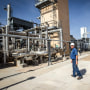 A plant operator at the Federal Helium Reserve walks through the Federal Crude Helium Enrichment Unit near Amarillo, Texas, on July 6, 2011.