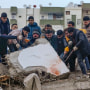 Men search for survivors in the debris in Adana, Turkey, on Feb. 6, 2023.