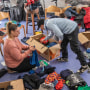 Workers sort clothes for aid shipments to Turkey and Syria in Stuttgart, Germany, on Feb. 7, 2023.
