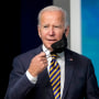 President Joe Biden removes his mask before speaking about the coronavirus pandemic in Washington on Oct. 14, 2021.