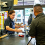 A cashier rings up a customer in a grocery store