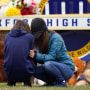 Mourners grieve at Oxford High School in Oxford, Mich.
