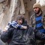 Residents retrieve a child from the rubble in Jandaris in a rebel-held area of Syria's Aleppo province.