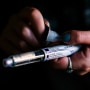 A person fastens a needle on a Sanofi Lantus brand SoloStar insulin pen in New York on April 5, 2019.