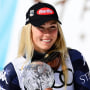 Mikaela Shiffrin hold the crystal globe while she celebrates her Women's Slalom victory