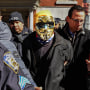  A man in a gold Anonymous mask is detained at a protest against Drag Queen story hour outside of The Center, a support space for LGBTQ+ people on March 19, 2023 in New York City. 
