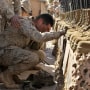 A U.S. Marine cries during the memorial service for 31 killed U.S. servicemen at Camp Korean Village, near Rutbah, western Iraq 