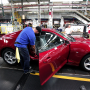 Workers put the finishing touches on a new General Motors 2016 Chevrolet Camaro as it rolls off the production line at GM's Lansing Grand River Assembly Plant October 26, 2015 in Lansing, Michigan. The Gen Six Camaro is the first to be produced in the United States since the third generation Camaro in 1992.