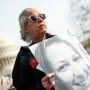 Micki Witthoeft holds a photograph of her late daughter Ashli Babbitt during a protest at the Capitol