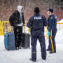 Migrants from Venezuela, Nigeria, HaÃ¯ti and other countries arrive at the Roxham Road border crossing in Roxham, Quebec, on March 2, 2023. - In 2022, the number of asylum seekers who crossed into Quebec via this road exceeded 39,000, doubling a previous record from 2017.