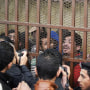 Men accused of "debauchery" are held behind bars in a court in Cairo