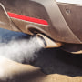 A car exhaust emits fumes.