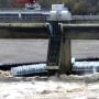 Three barges were pinned against structures, including a dam facility, after 10 became loose on the river in Louisville, Ky.