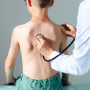 Doctor checking boy's lungs With a stethoscope