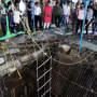 Up to 35 people fell into the well in the temple complex when the structure collapsed and were covered by falling debris, police Commissioner Makrand Deoskar said. At least eight were killed. 