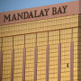 Drapes billow out of broken windows at the Mandalay Bay resort and casino Monday, Oct. 2, 2017, on the Las Vegas Strip following a deadly shooting at a music festival in Las Vegas. A gunman was found dead inside a hotel room. 