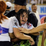 A woman cries following a stampede during a football match between Alianza and FAS at Cuscatlan stadium in San Salvador, El Salvador, on May 20, 2023.