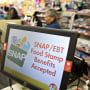 "SNAP/EBT Food Stamp Benefits Accepted" is displayed on a screen inside a Family Dollar Stores Inc. store in Chicago, Ill