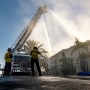 Firefighters with the pour water on a home that was destroyed in a coastal fire