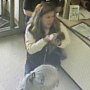 A woman carries a baby raccoon into a Petco in Auburn, Maine