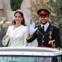 Image: Jordan's Crown Prince Hussein and his wife Saudi Rajwa al-Seif wave as they leave the Zahran Palace in Amman on June 1, 2023 following their royal wedding ceremony. 