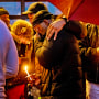 Family members console each other at a vigil for Keenan Anderson