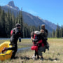 10-year-old Shunghla Mashwani is greeted by members of her family after being rescued in the Cle Elum River Valley, Wash., on June 5, 2023.