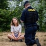 Police officers talk to climate activist Greta Thunberg as they move activists from the organization "Take back the future" who are blocking the entrance to the Oljehamnen neighbourhood in Malmo, Sweden, on June 19, 2023.