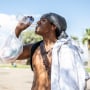 Alonzo McAdams drinks a bottle of water from a Salvation Army truck handing out water, and other supplies for the homeless in Tucson on July 26, 2023. 
