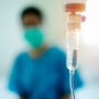 Doctor wearing surgical mask and infusion for patient 