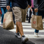 Shoppers carry retail bags along the Magnificent Mile shopping district in Chicago on Aug. 15, 2023.