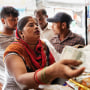 Raj Kumari, 30, shops for rations at a shop in New Delhi on Sept. 5, 2023.