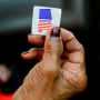 Sadie Janes shows off her voting sticker after casting her ballot during the Democratic presidential primary in Montgomery, Ala., on March 3, 2020.