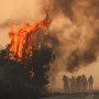 Firefighters work to extinguish a fire in Evros, Greece, on Aug. 31, 2023. Greek Special Forces rescue a resident from the flooded Koskinas village on Sept. 9, 2023.