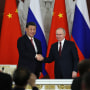 Russian President Vladimir Putin and China’s President Xi Jinping shake hands after delivering a joint statement following their talks at the Kremlin in Moscow