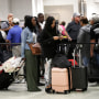 Passengers wait in line at a security checkpoint at Miami International Airport in Miami amid the government shutdown, on Jan. 18, 2019. 