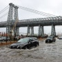 Motorists drive through floodwaters on FDR Drive in Manhattan near the Williamsburg Bridge on Friday, Sept. 29, 2023.