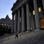 A court officer walks down the stairs in front of the New York Supreme Court in preparation for former President Donald Trump's arrival on Monday, Oct. 2, 2023.