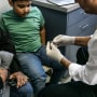 Pediatrician shows the Covid vaccine to a 7-year-old