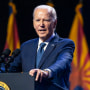 President Joe Biden speaks speaks onstage at a podium