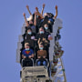 Visitors ride a roller coaster at Six Flags Magic Mountain in Valencia, Calif., on April 1, 2021. 