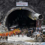 Indian rescue teams digging by hand are on the verge of breaking through to reach 41 men trapped in a collapsed road tunnel, officials said Tuesday, raising hopes the end of the marathon 17-day operation is in sight. 
