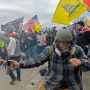 Trump supporters, including the "blueplaidsprayer," clash with police at the Capitol on Jan. 6, 2021.