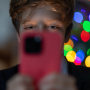 A 12-year-old boy looks at an iPhone screen on December 19, 2023, in Bath, England.